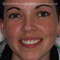 A portrait photograph of a person smiling